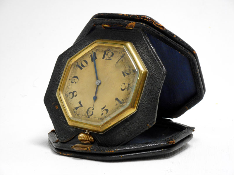 Lot 55 - A Black Leather-Cased Octagonal Travelling Time Clock