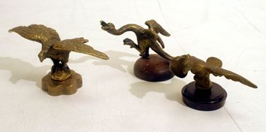 Lot 310 - Three Brass 'Winged' Accessory Mascots